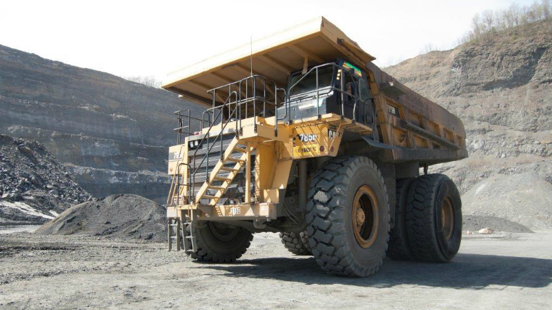 yellow dump truck in quarry